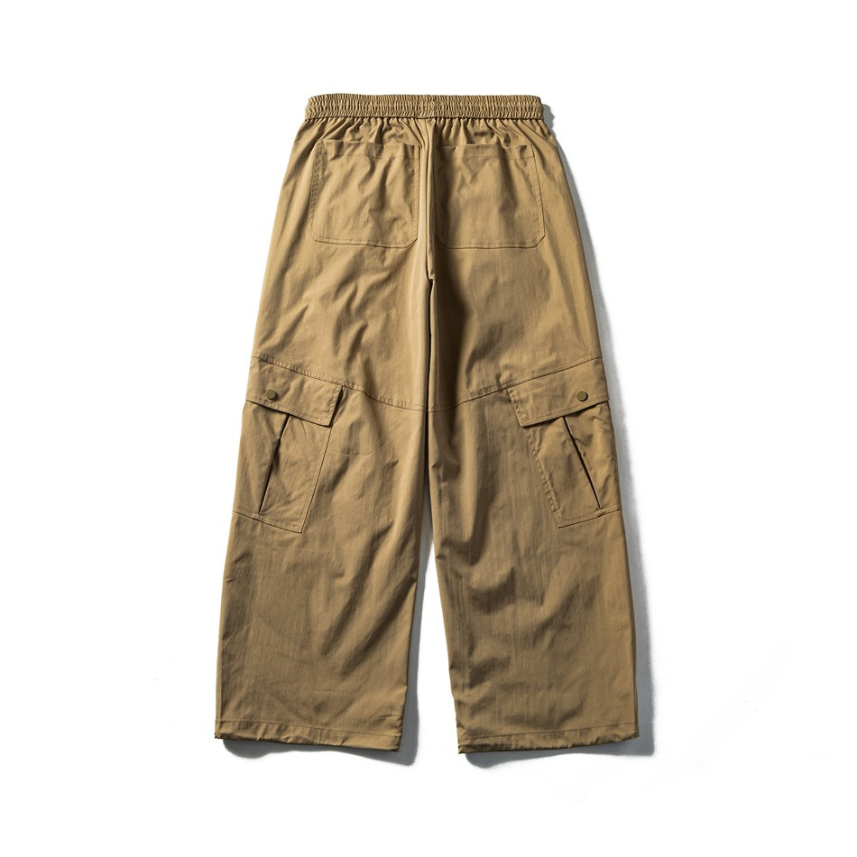 Back view of khaki cargo pants showing two patch pockets, elastic waistband and snap-flap side cargo pockets