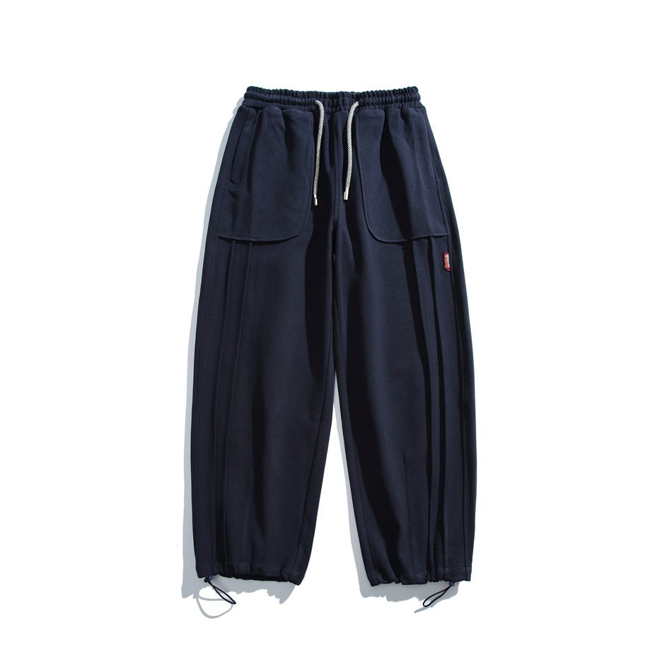 Navy wide-leg sweatpants flat lay with drawstring waist, front patch pockets and drawstring ankle hems