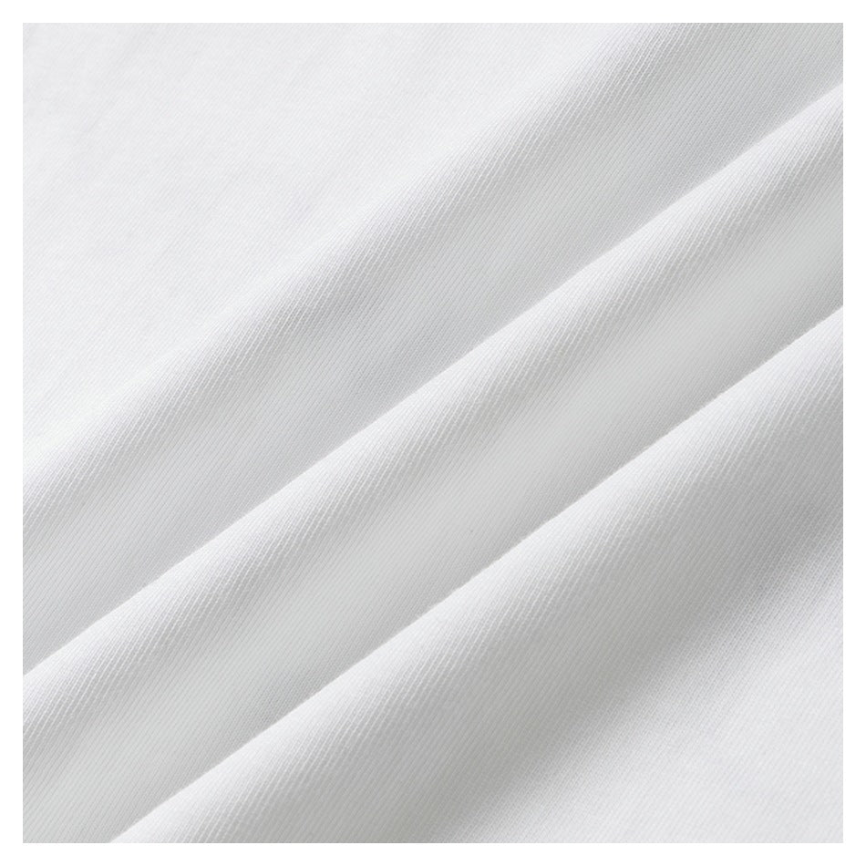 Close-up of white fabric draped in folds, showing its fine surface texture.