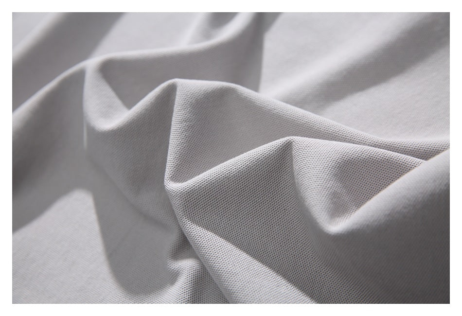 Close-up showing the textured surface of light gray shirt fabric.