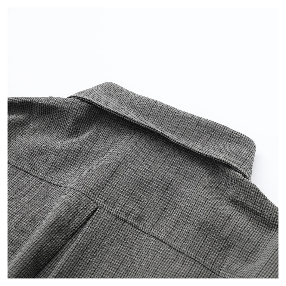 Close-up of the gray micro-check shirt's collar and back shoulder seam.