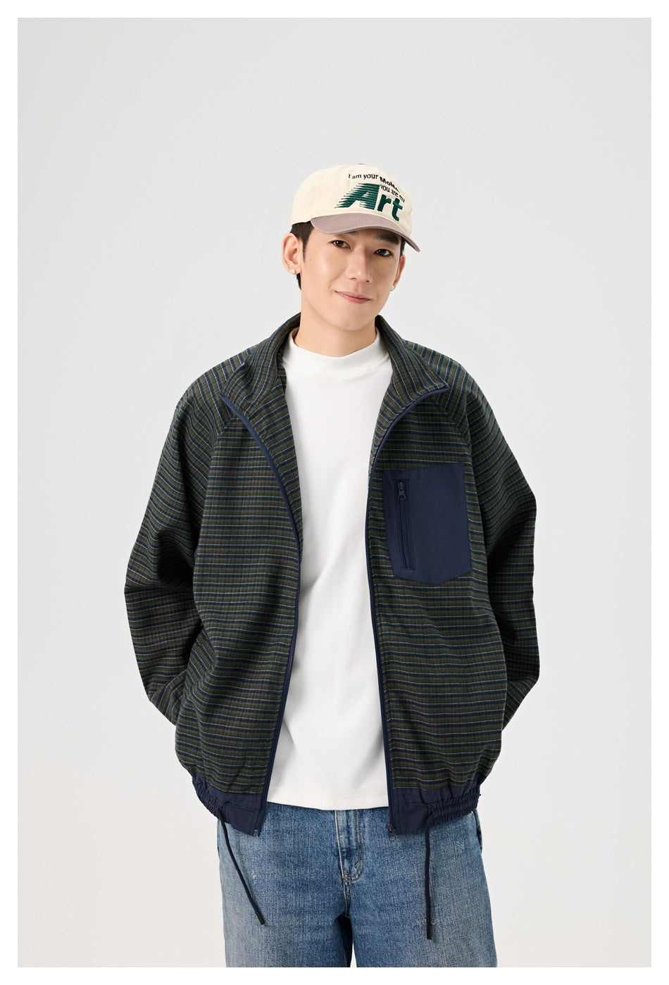 Model wearing an open dark striped jacket with a navy zip chest pocket over a white shirt.