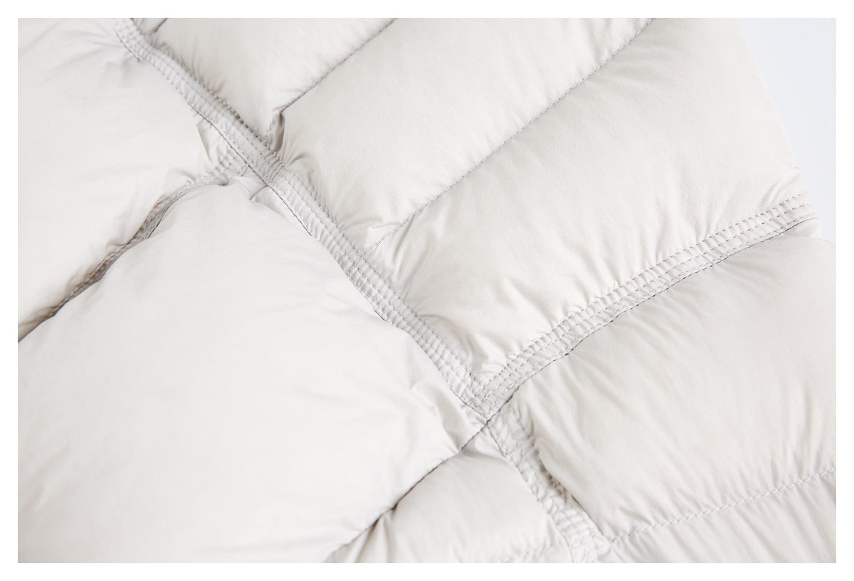Close-up of the off-white jacket's quilted panels and intersecting rows of stitching.