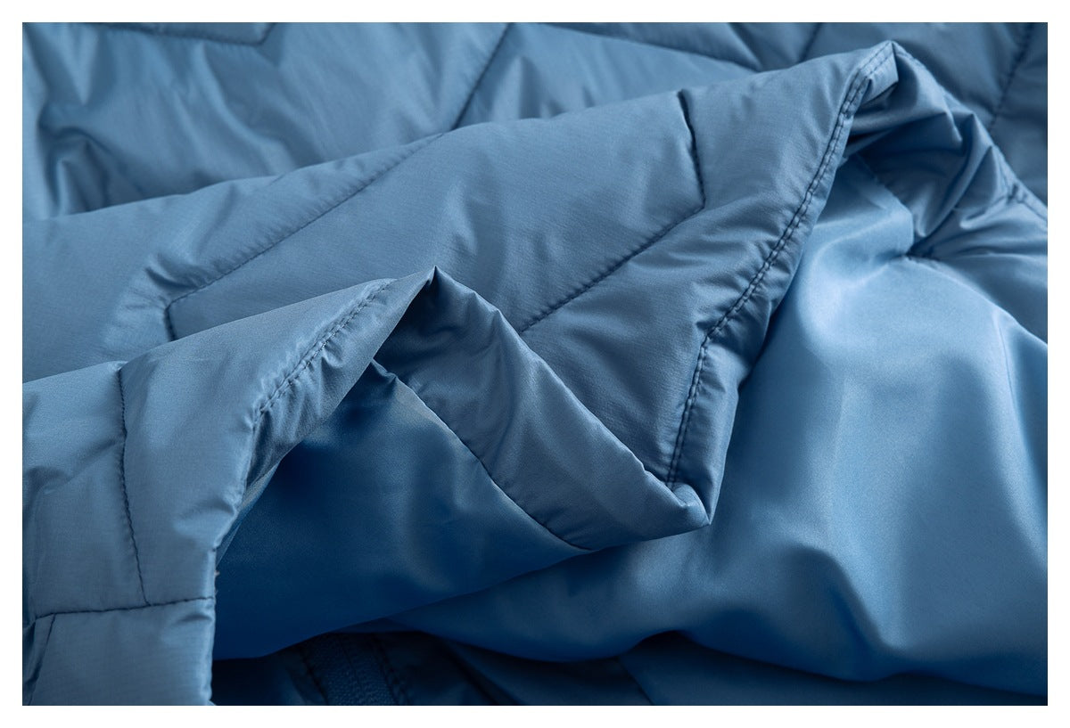 Close-up showing the blue jacket's folded inner fabric, seams, and stitching.