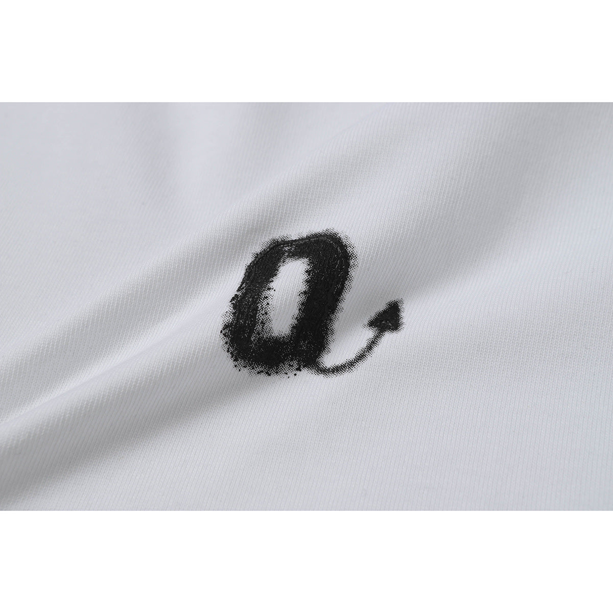 Close-up of a small black loop-and-arrow graphic printed on white shirt fabric.