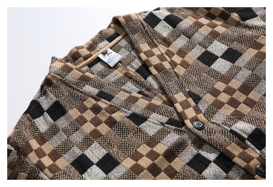 Cropped flat lay of the shirt's upper front, showing its multitone check pattern, collar, and button placket.