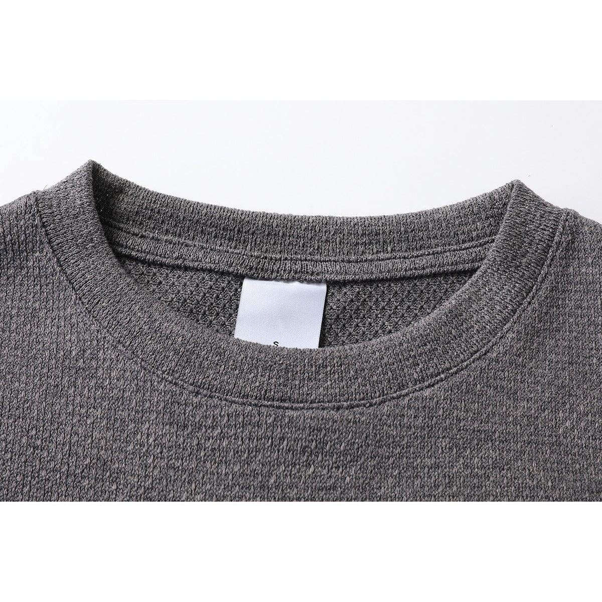 Close-up of a charcoal gray sleeveless top's crew neckline and inner size label.