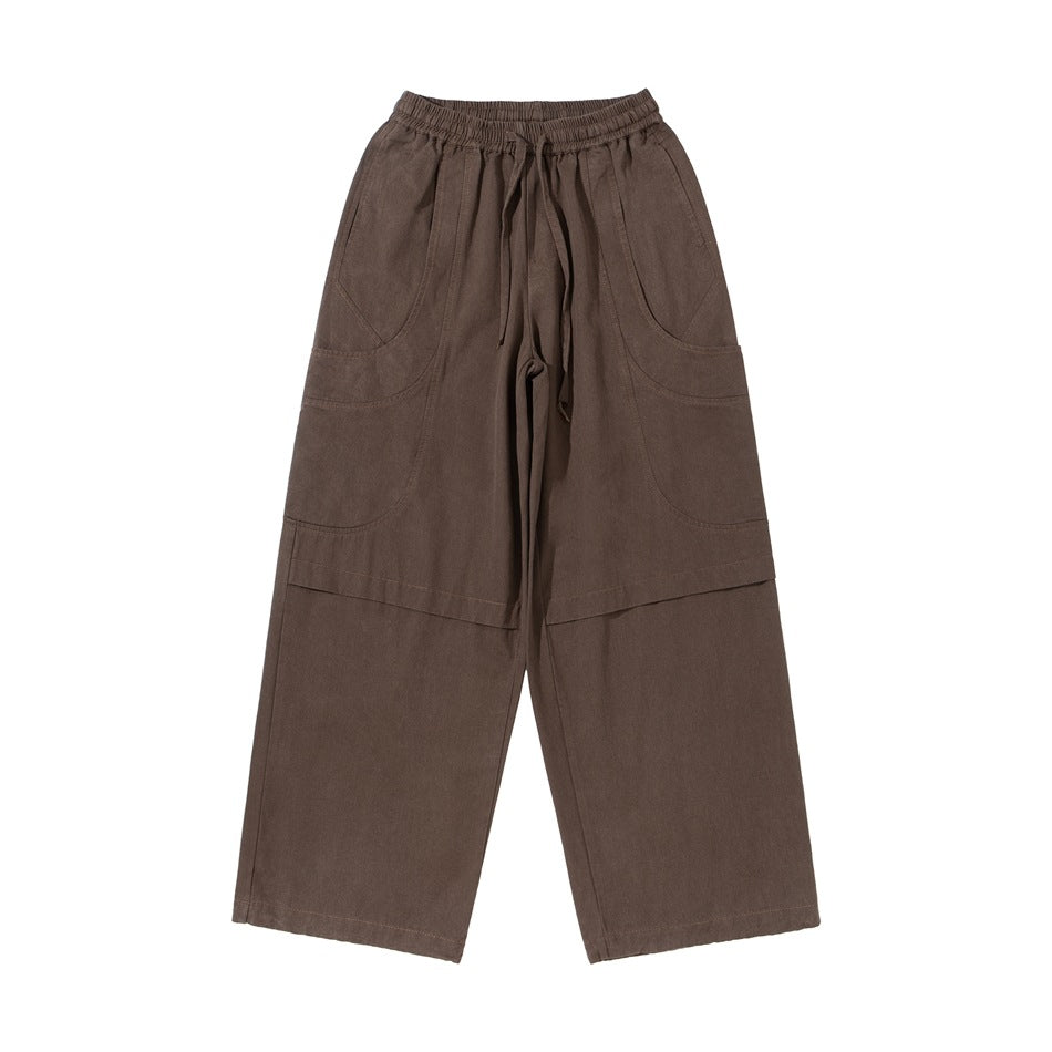 Brown wide-leg cargo pants flat lay, front view with elastic drawstring waist and large curved side pockets
