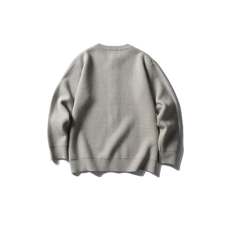 Back view of a light gray textured knit cardigan with long sleeves and ribbed cuffs and hem.