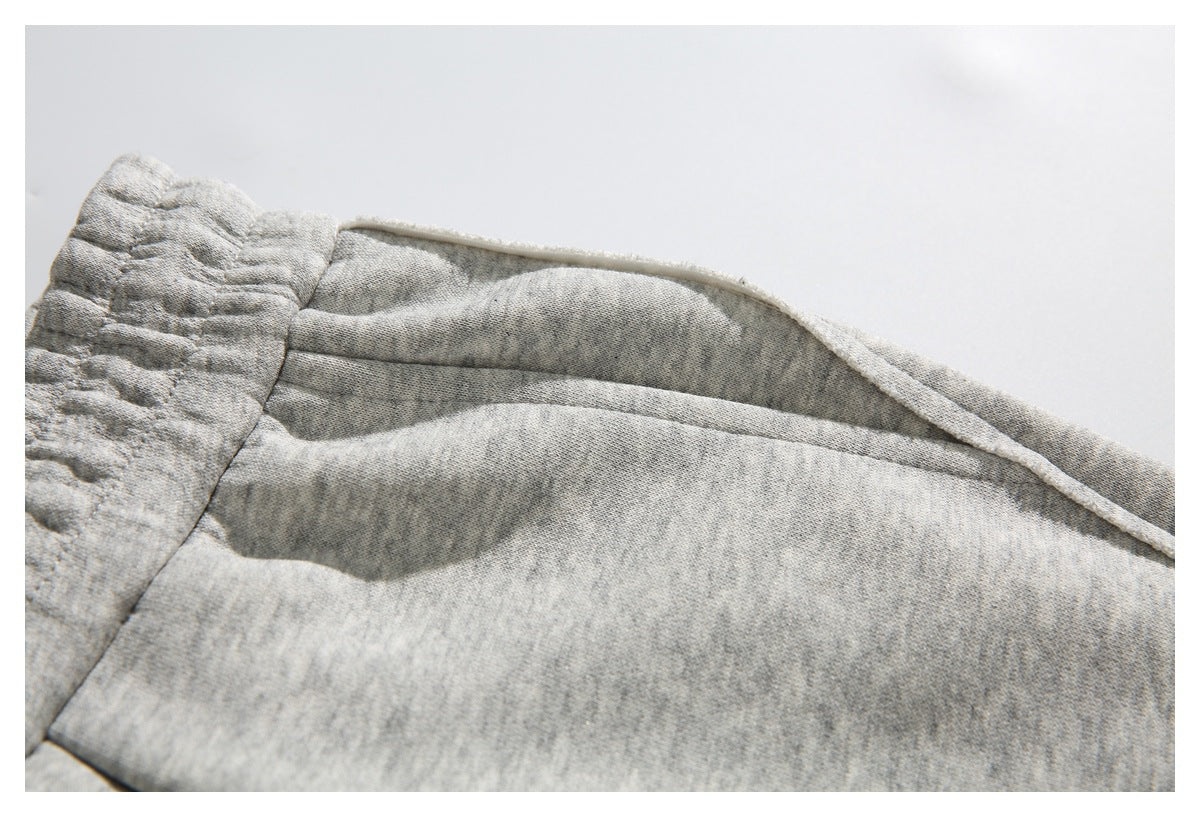 Close-up of the inside waistband and fabric construction of light gray heather sweatpants.