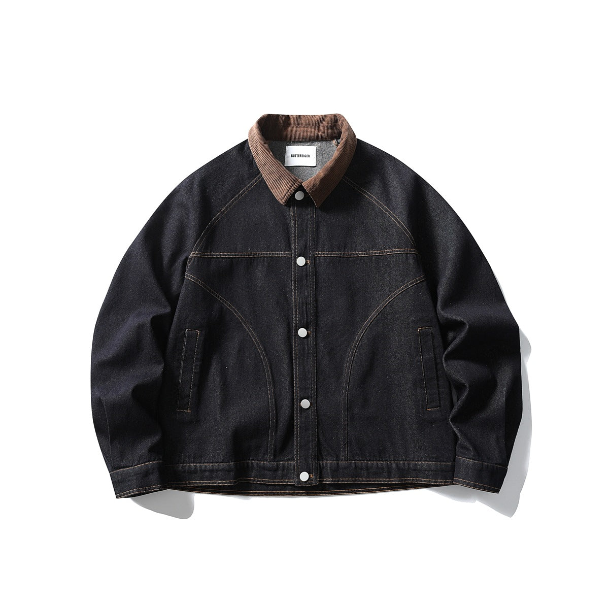 Dark indigo denim jacket with brown corduroy collar, snap buttons and contrast stitching, flat lay front view
