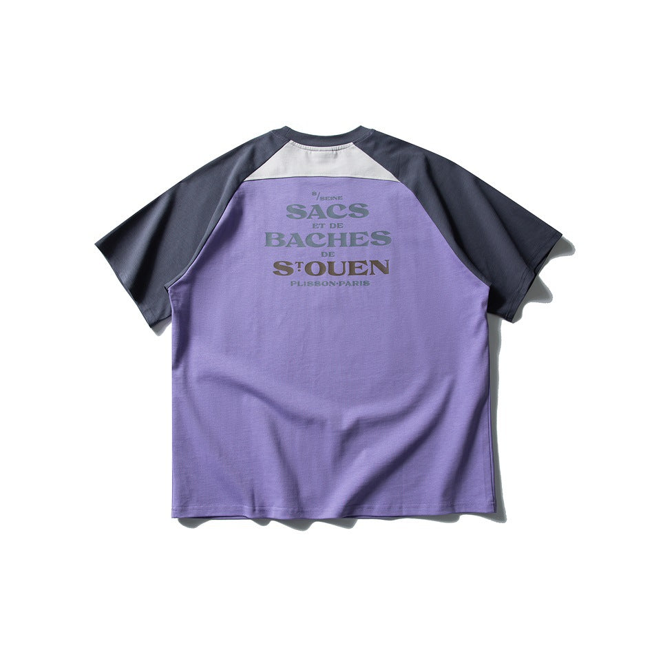 Back of purple raglan T-shirt with dark slate sleeves, light shoulder panel and muted text graphic