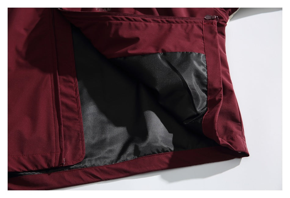 Close-up of the burgundy jacket opened to show its black interior lining and inner construction.
