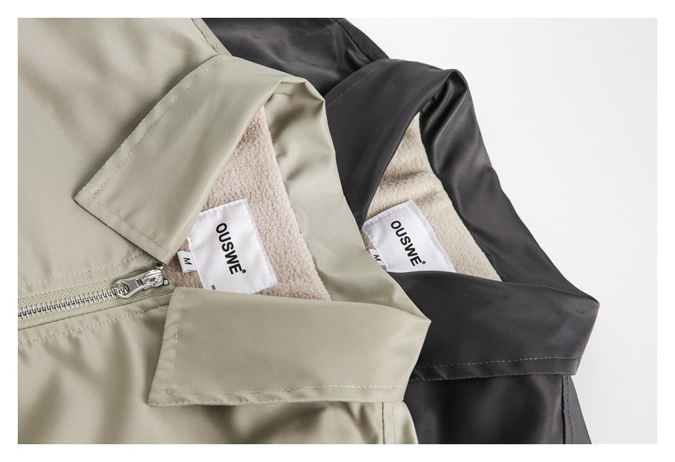 Close-up of beige and black jackets showing fleece-like lining, zipper details, and sewn-in labels.