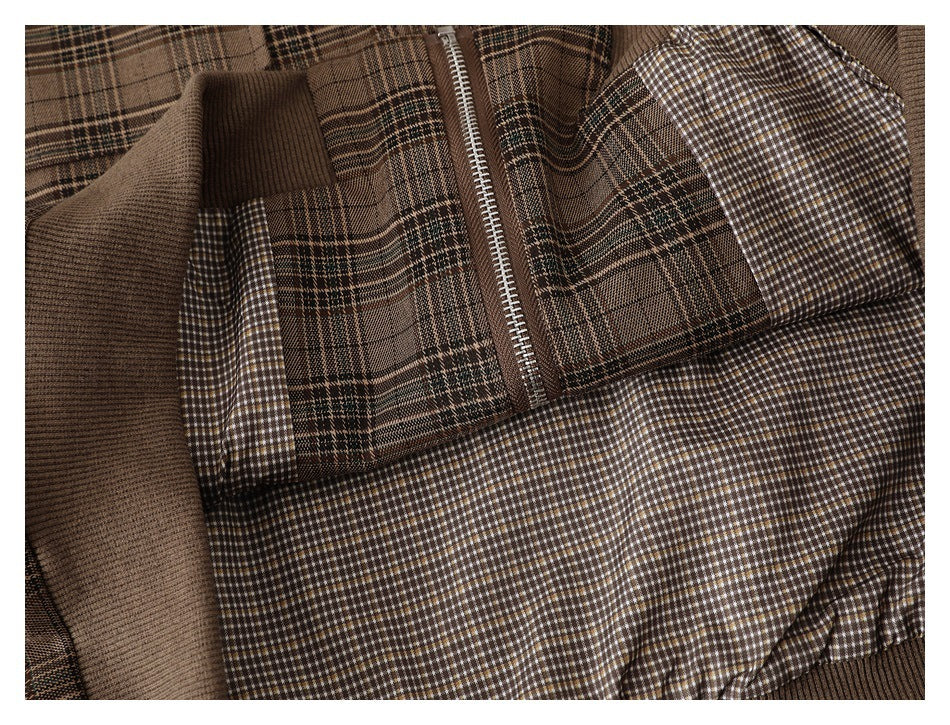 The brown plaid jacket is opened to show its small-check lining, ribbed trim, and front zipper.