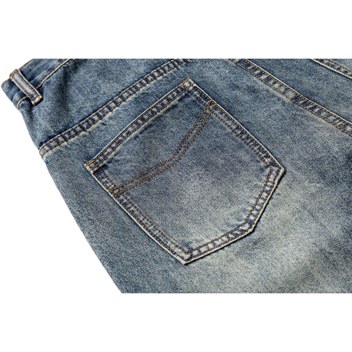 Close-up of the back of blue faded jeans, centered on a stitched back pocket.