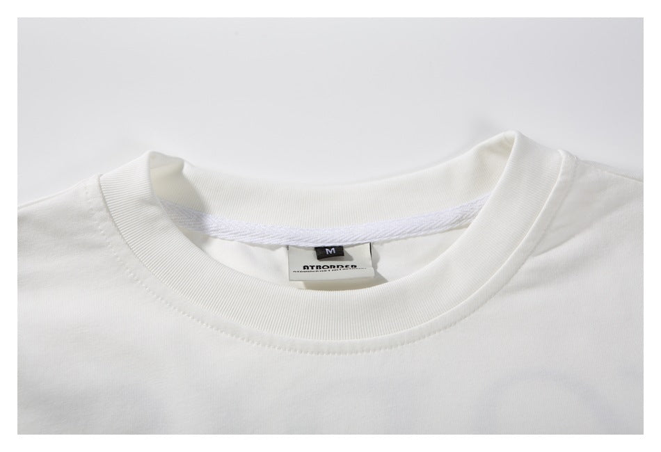 Close-up of the white T-shirt's ribbed crew neckline and sewn-in size M label.