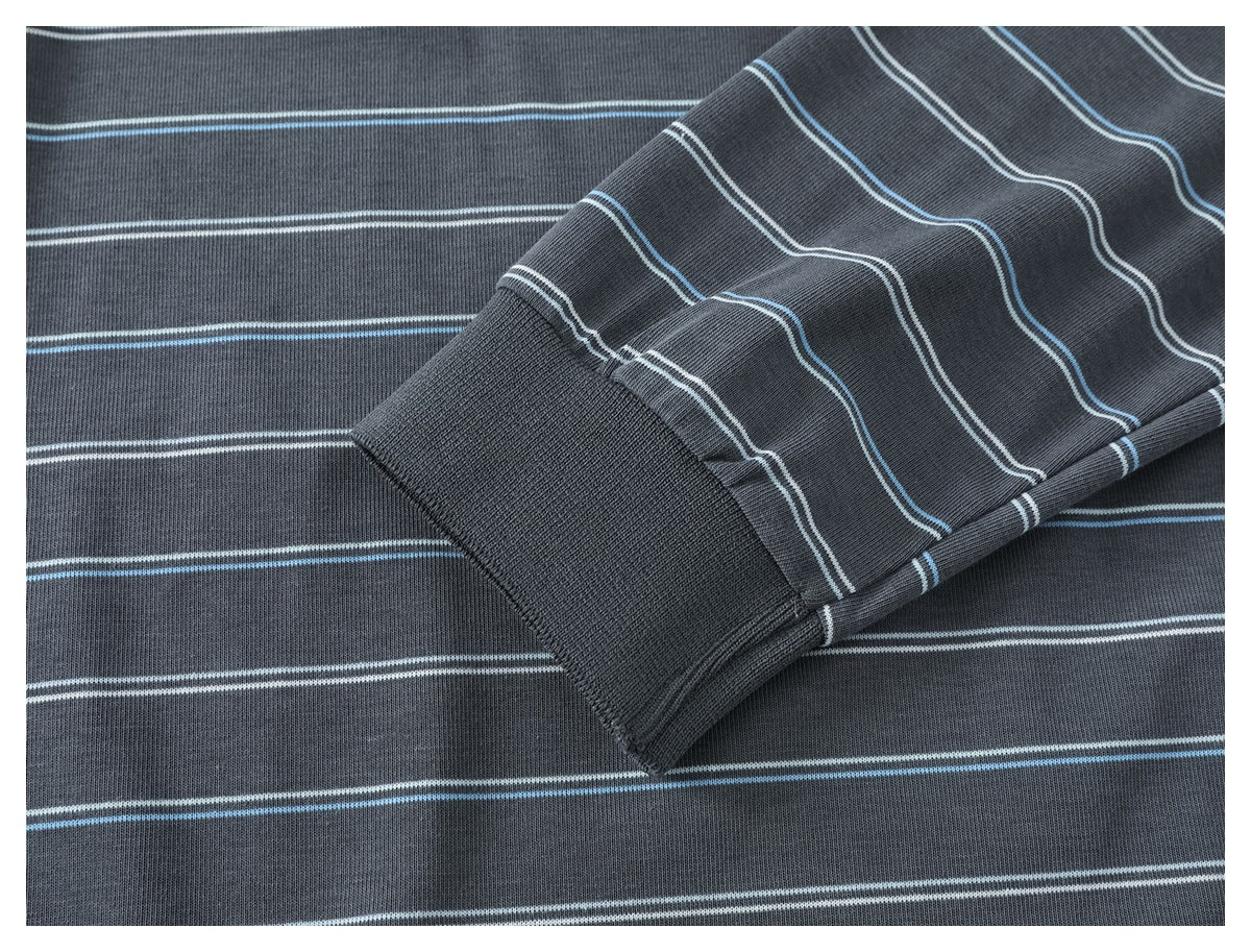 Close-up of a charcoal gray striped shirt sleeve and solid ribbed cuff.
