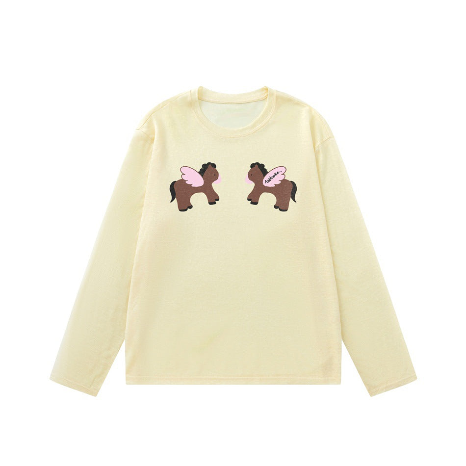 Pale yellow long-sleeve crew neck top with two mirrored brown winged ponies printed on the chest