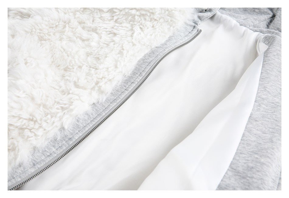 Close-up of the open garment's metal zipper, white lining, shaggy trim, and heather-gray fabric.
