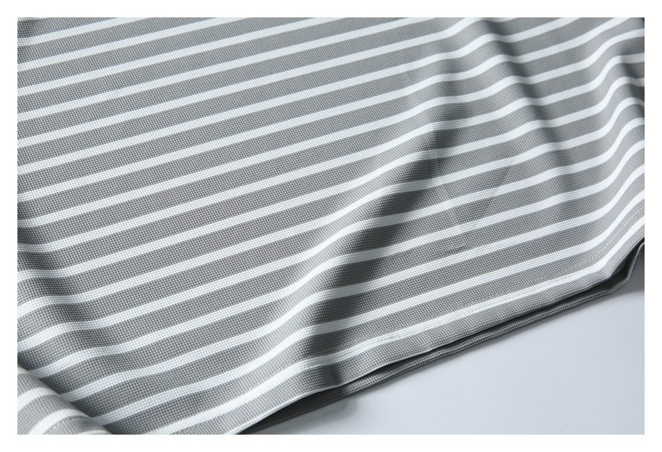 Close-up of gray-and-white striped garment fabric with a textured weave and curved folds.