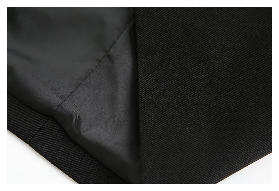 Close-up showing the black garment's smooth dark lining and outer fabric.