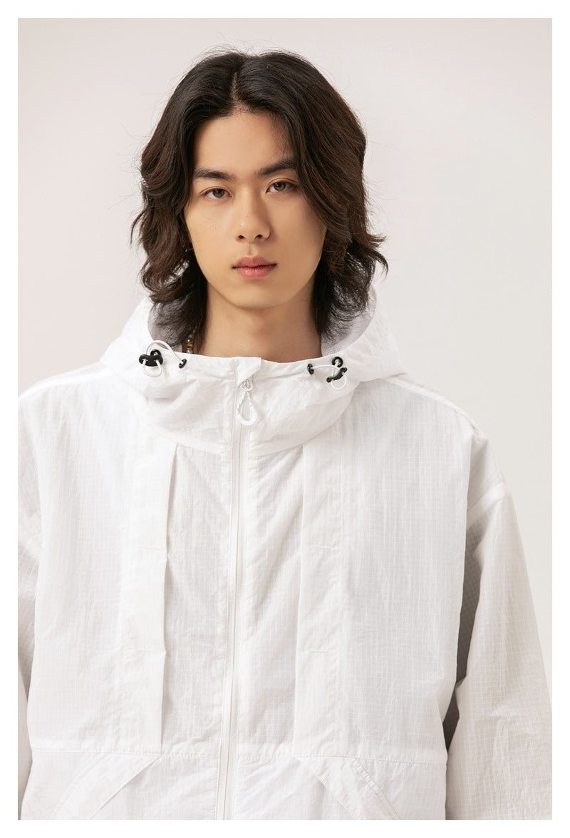Close view of a model wearing a white hooded zip jacket with black drawcord hardware.