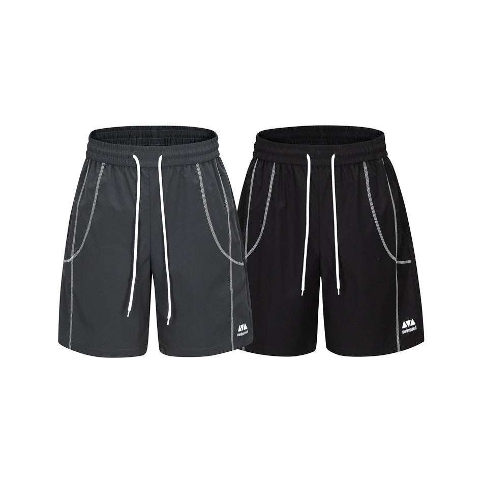 Two pairs of loose shorts shown from the front in charcoal gray and black, with white drawstrings and contrast stitching.