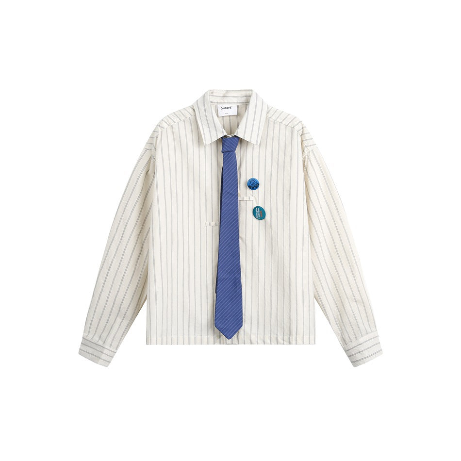 Off-white striped long-sleeve shirt flat lay with blue striped tie and two round badge pins on the chest