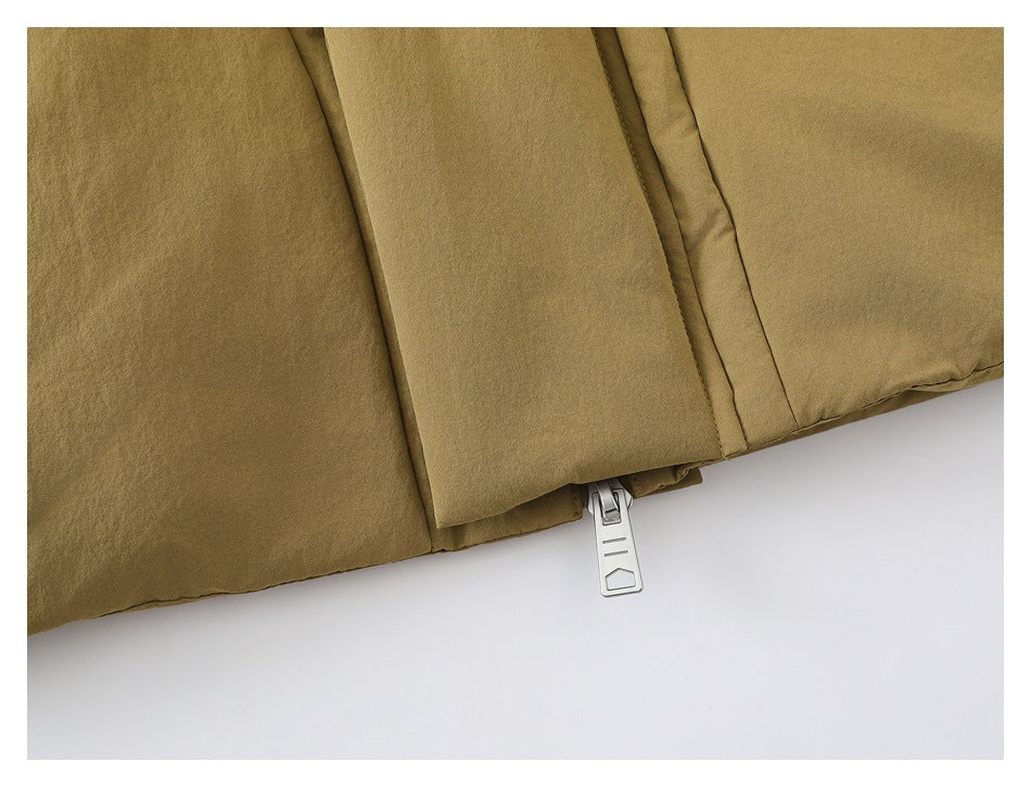Close-up of the tan jacket's lower front, covered zipper flap, and zipper pull.