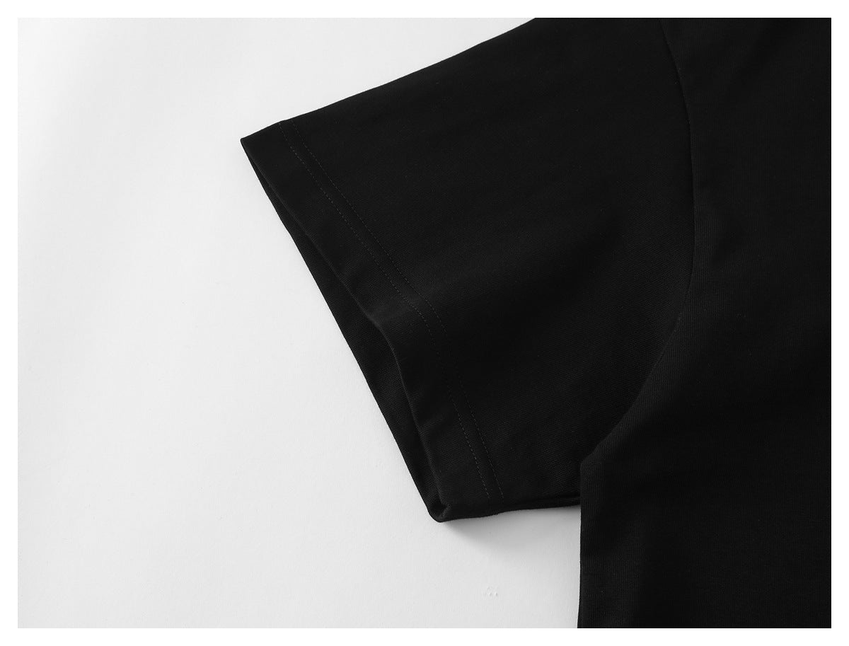 Close-up of a black short sleeve and its stitched hem.
