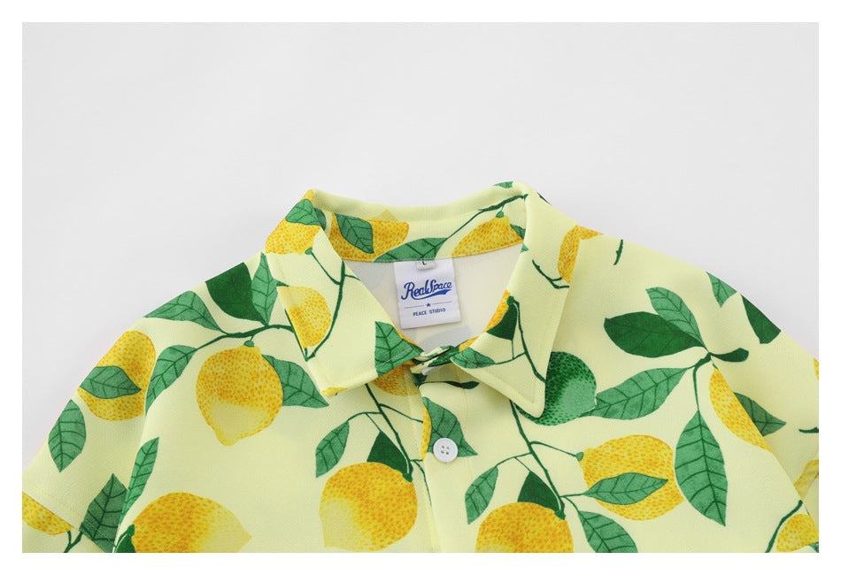 Close-up of the yellow lemon-print shirt's collar, buttons, and visible neck label.
