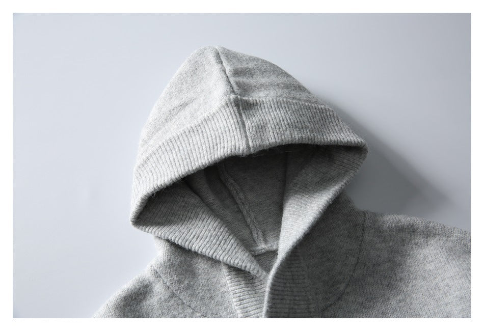 Close-up of the gray knit top's hood, showing its ribbed edge and inner seams.