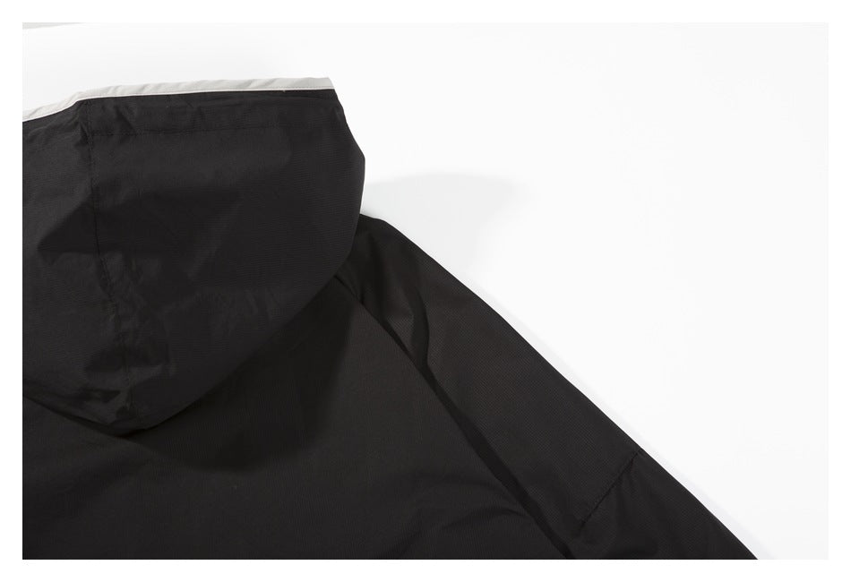 Close-up of the black garment's hood, showing white edging along its opening.