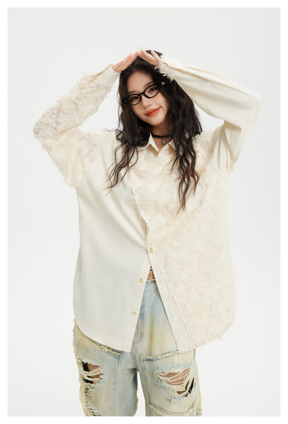 Model posing in an oversized ivory shirt with shaggy textured panels, smooth contrasting sections, and a chest pocket.