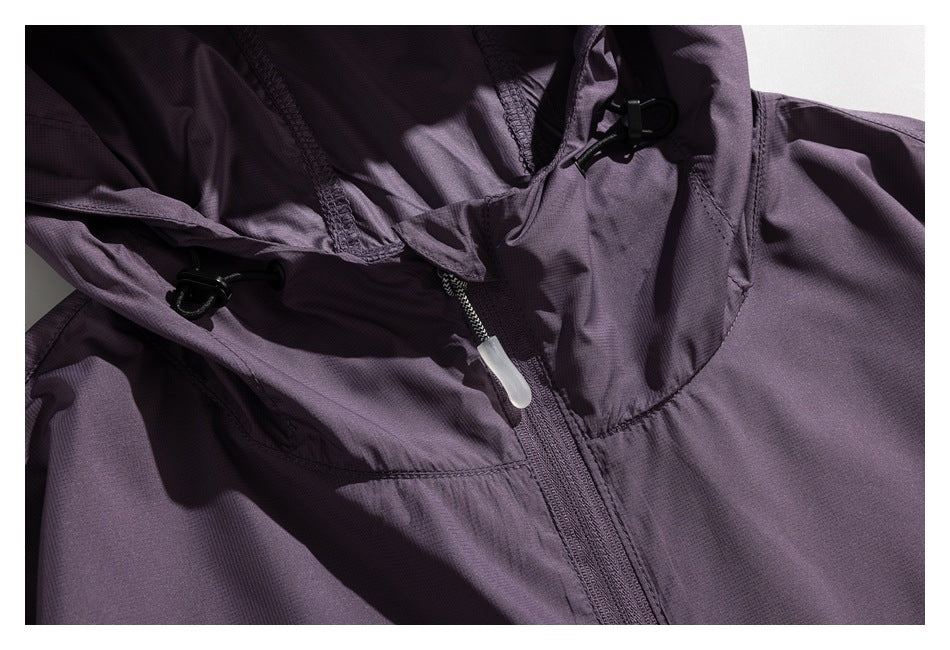 Close-up of a purple jacket hood with black adjustment toggles and a central zipper.