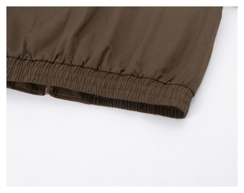 Close-up of the brown jacket's gathered elastic hem.