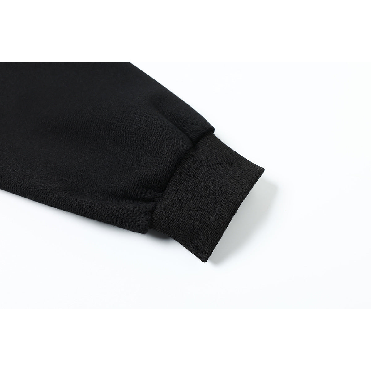 Close-up of a black sleeve ending in a wide ribbed cuff.