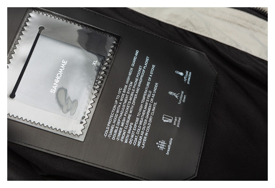Interior close-up of a dark garment label with English feature text and a clear pocket holding a size tag.