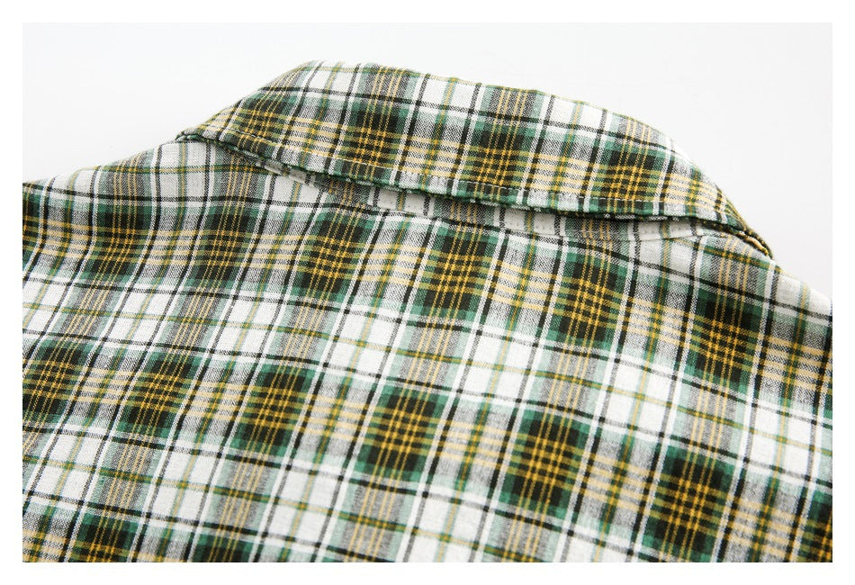 Close-up of the plaid shirt collar and upper back laid flat.