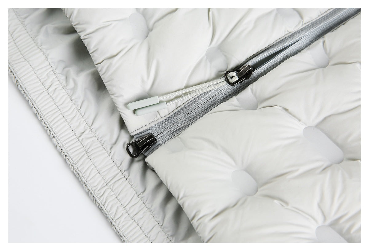 Close-up of the white jacket's hem stitching and gray zipper with two sliders and pull cords.