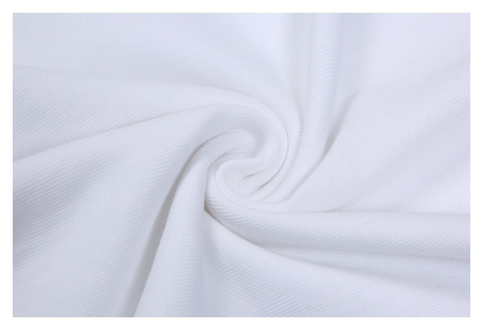 Close-up of white fabric arranged in soft folds, showing a fine textured surface.