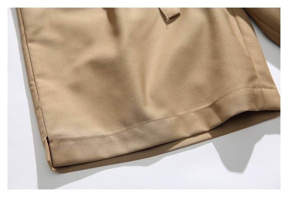 Close-up of the tan trouser leg and stitched bottom hem.