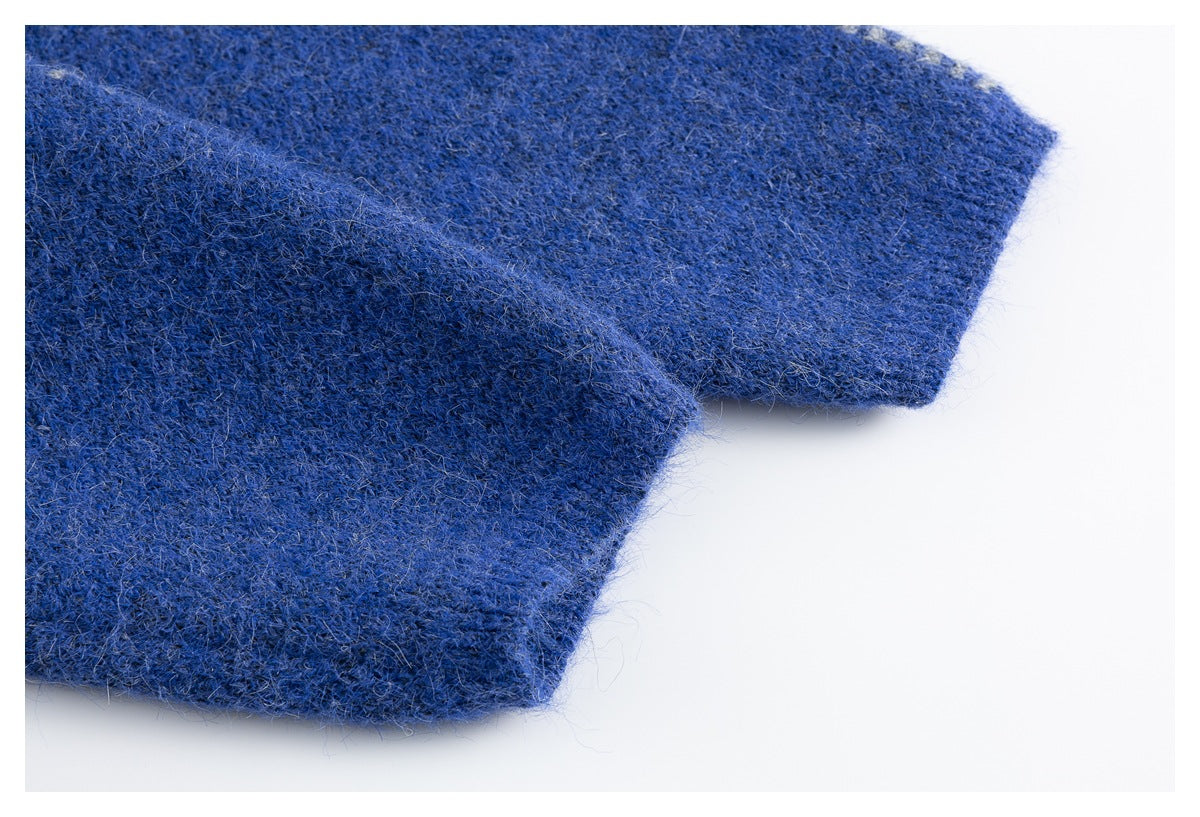 Close-up of the blue sweater's plain knit sleeve cuff and fuzzy fabric texture.