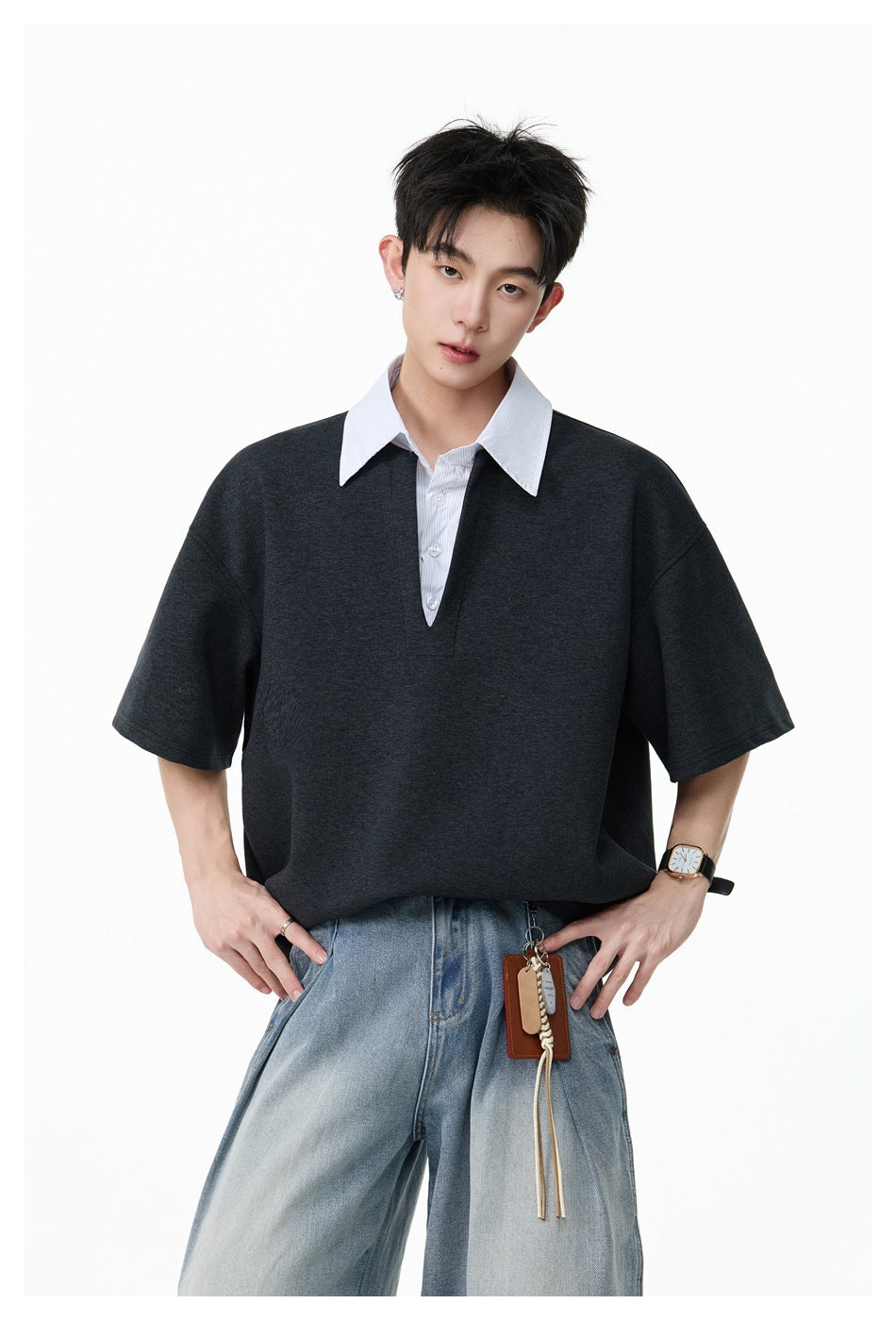 Closer view of a model wearing an oversized charcoal top with a white pinstriped collar and button placket.