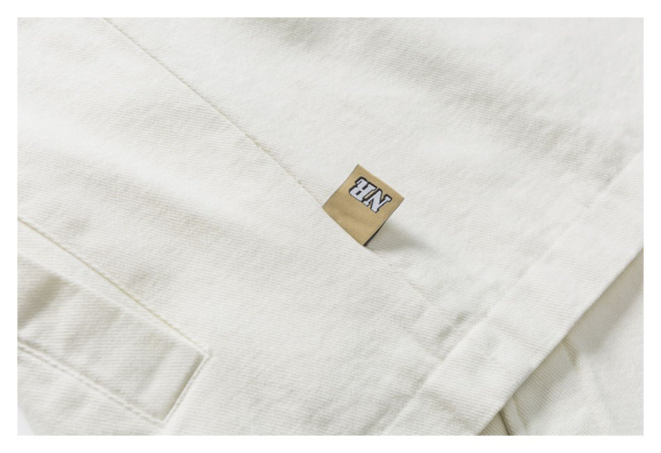 Close-up of an off-white garment with a small tan fabric label.