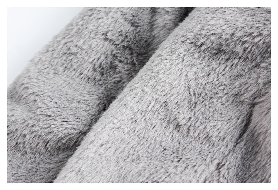 Close-up of plush gray faux-fur fabric with a mottled light and dark pile.