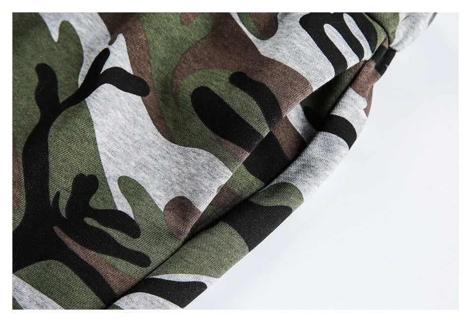 Close-up of the camouflage pants showing a stitched seam and folded fabric edge.