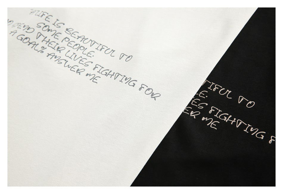 Close-up of white and black fabric with the same handwritten English quote print.