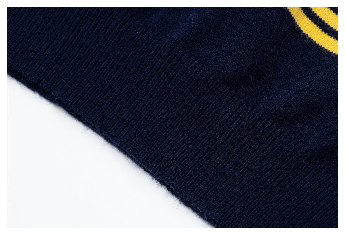 Close-up of a navy rib-knit edge with a small section of mustard-yellow stripe detail.